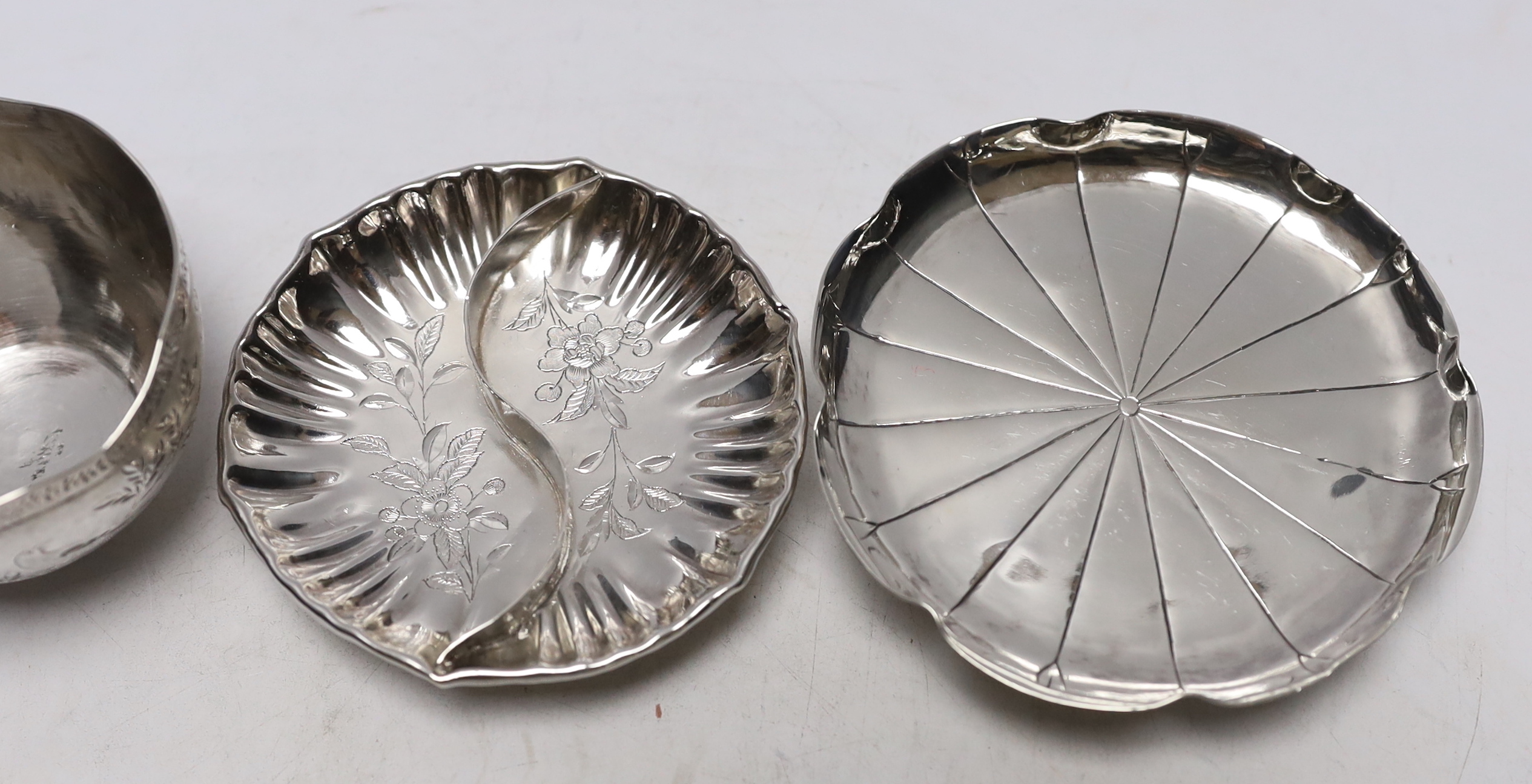 Chinese white metal items including two shaped dishes, a tea cup and two dragon dishes, largest 10.2cm, 8.2oz.